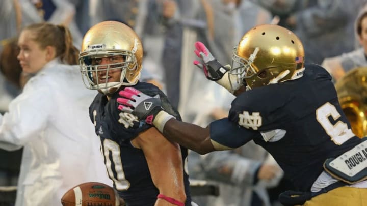 SOUTH BEND, IN - OCTOBER 13: Theo Riddick #6 of the Notre Dame Fighting Irish moves to celebrate with Tyler Eifert #80 after Eifert caught a touchdown pass against the Standford Cardinal at Notre Dame Stadium on October 13, 2012 in South Bend, Indiana. Notre Dame defeated Stanford 20-13 in overtime. (Photo by Jonathan Daniel/Getty Images)