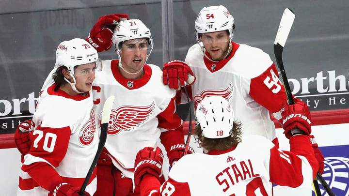 CHICAGO, ILLINOIS – JANUARY 22: Dylan Larkin #71 of the Detroit Red Wings (center) celebrates a third period goal with teammates (L-R) Troy Stecher #70, Bobby Ryan #54 and Marc Staal #18 against the Chicago Blackhawks at the United Center on January 22, 2021 in Chicago, Illinois. The Blackhawks defeated the Red Wings 4-1. (Photo by Jonathan Daniel/Getty Images)