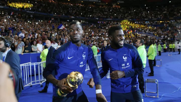 PARIS, FRANCE - SEPTEMBER 09:Paul Pogba and Samuel Umtiti of France celebrate the FIFA World Cup with fan after the UEFA Nations League A group one match between France and Netherlands at Stade de France on September 9, 2018 in Paris, France. (Photo by Xavier Laine/Getty Images)