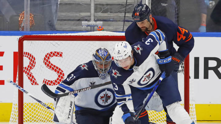 May 19, 2021; Edmonton, Alberta, CAN;Edmonton Oilers forward Zack Kassian (44) battles for a loose puck Winnipeg Jets defensemen Tucker Poolman (3) in front of goaltender Connor Hellebuyck (37) during the second period in game one of the first round of the 2021 Stanley Cup Playoffs at Rogers Place. Mandatory Credit: Perry Nelson-USA TODAY Sports