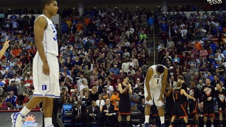 Mar 21, 2014; Raleigh, NC, USA; Duke Blue Devils forward Jabari Parker (1) and Duke Blue Devils guard Andre Dawkins (34) react in the closing second of their game against the Mercer Bears of a men