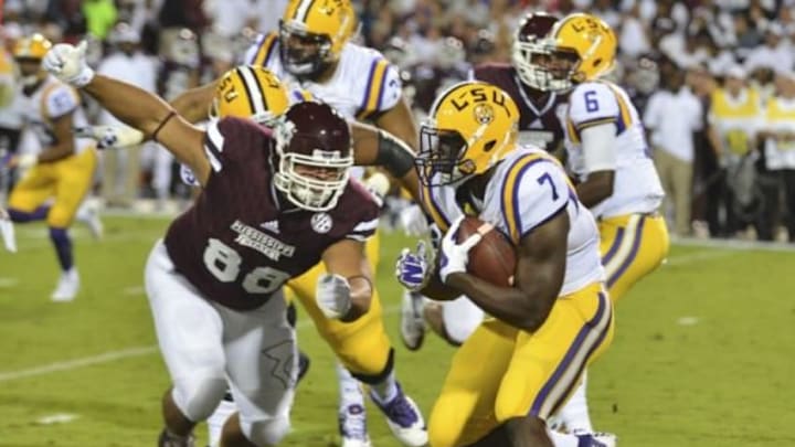 Sep 12, 2015; Starkville, MS, USA; LSU Tigers running back Leonard Fournette (7) is defended by Mississippi State Bulldogs defensive lineman Nick James (88) during the first quarter at Davis Wade Stadium. Mandatory Credit: Matt Bush-USA TODAY Sports
