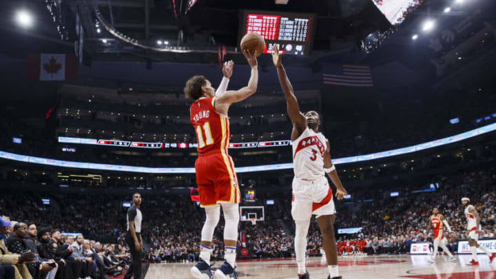 TORONTO, ON - OCTOBER 31: Trae Young #11 of the Atlanta Hawks puts up a shot over O.G. Anunoby #3 of the Toronto Raptors (Photo by Cole Burston/Getty Images