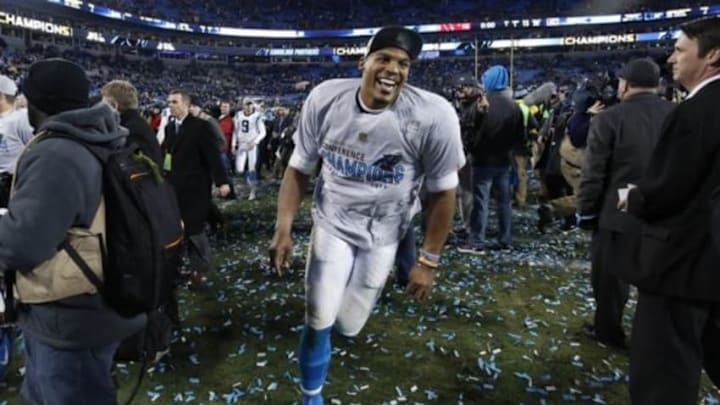 Carolina Panthers quarterback Cam Newton (1) runs on the field after the NFC Championship football game against the Arizona Cardinals at Bank of America Stadium. The Panthers won 49-15. Mandatory Credit: Jason Getz-USA TODAY Sports
