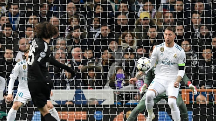 TOPSHOT - Paris Saint-Germain's French midfielder Adrien Rabiot (L) kicks the ball in front of Real Madrid's Spanish defender Sergio Ramos (R) during the UEFA Champions League round of sixteen first leg football match Real Madrid CF against Paris Saint-Germain (PSG) at the Santiago Bernabeu stadium in Madrid on February 14, 2018. / AFP PHOTO / GABRIEL BOUYS (Photo credit should read GABRIEL BOUYS/AFP/Getty Images)