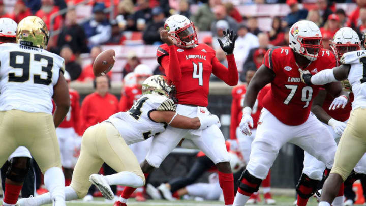 LOUISVILLE, KY - OCTOBER 27: Jawon Pass #4 of the Louisville Cardinals fumbles the ball as he is hit by Demetrius Kemp #34 of the Wake Forest Demon Deacons on October 27, 2018 in Louisville, Kentucky. (Photo by Andy Lyons/Getty Images)