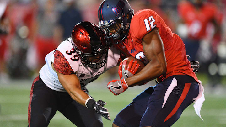 Oct 1, 2016; Mobile, AL, USA; San Diego State Aztecs linebacker Ronley Lakalaka (39) tacklers South Alabama Jaguars tight end Gerald Everett (12) in the first quarter at Ladd-Peebles Stadium. Mandatory Credit: