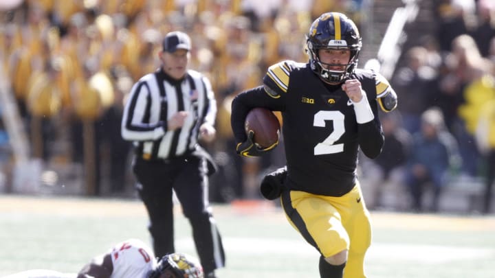 IOWA CITY, IOWA- OCTOBER 20: Quarterback Peyton Mansell #2 of the Iowa Hawkeyes runs up the field on a keeper during the second half in front of linebacker Durell Nchami #30 of the Maryland Terrapins on October 20, 2018 at Kinnick Stadium, in Iowa City, Iowa. (Photo by Matthew Holst/Getty Images)