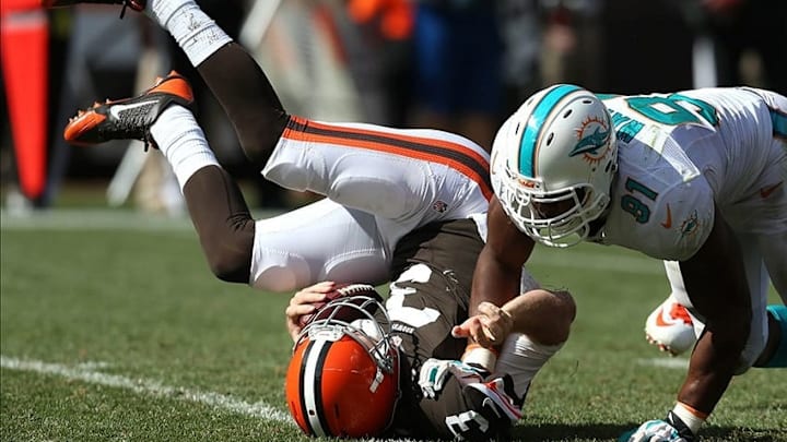 Sep 8, 2013; Cleveland, OH, USA; Miami Dolphins defensive end Cameron Wake (91) sacks Cleveland Browns quarterback Brandon Weeden (3) during the fourth quarter at FirstEnergy Field. The Dolphins won 23-10. Mandatory Credit: Ron Schwane-USA TODAY Sports