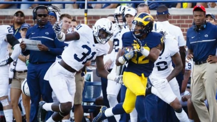 Sep 24, 2016; Ann Arbor, MI, USA; Michigan Wolverines running back Chris Evans (12) rushes past Penn State Nittany Lions linebacker Cameron Brown (31) in the second half at Michigan Stadium. Michigan 49-10. Mandatory Credit: Rick Osentoski-USA TODAY Sports