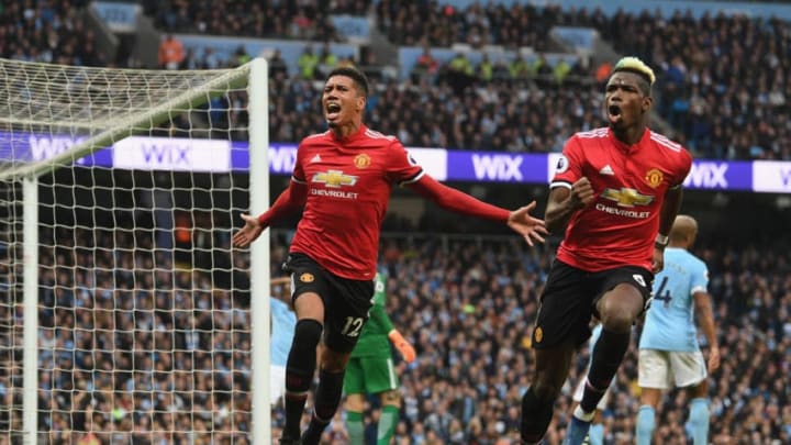 MANCHESTER, ENGLAND - APRIL 07: Chris Smalling of Manchester United celebrates scoring his side's third goal with Paul Pogba during the Premier League match between Manchester City and Manchester United at Etihad Stadium on April 7, 2018 in Manchester, England. (Photo by Michael Regan/Getty Images)