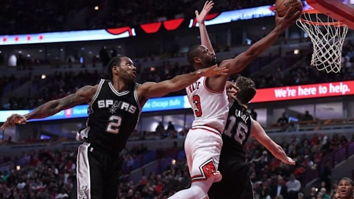 Dec 8, 2016; Chicago, IL, USA; Chicago Bulls guard Dwyane Wade (3) shoots the ball against San Antonio Spurs forward Kawhi Leonard (2) and center Pau Gasol (16) during the second half at the United Center. Chicago defeated San Antonio 95-91. Mandatory Credit: Mike DiNovo-USA TODAY Sports