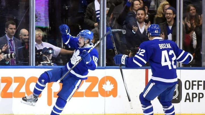 Oct 15, 2016; Toronto, Ontario, CAN; Toronto Maple Leafs forward Mitch Marner (16) celebrates his first career goal with forward Tyler Bozak (42 during the first period against Boston Bruins at Air Canada Centre. Mandatory Credit: Dan Hamilton-USA TODAY Sports