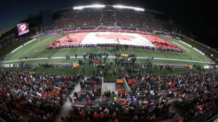OTTAWA, ON - OCTOBER 24: The largest Canadian flag in the world is unfurled to show solidarity after the terror attack in Ottawa earlier in the week, prior to the game between the Ottawa Redblacks and the Montreal Alouettes at TD Place Stadium on October 24, 2014 in Ottawa, Ontario, Canada. (Photo by Jana Chytilova/Freestyle Photography/Getty Images)