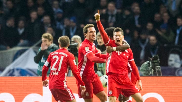 Munich´s Polish forward Robert Lewandowski (R) celebrates after scoring with his teamate defender Philipp Lahm, defender Mats Hummel and Austrian defender David Alaba during the German First division Bundesliga football match Hertha Berlin vs Bayern Munich in Berlin, eastern Germany, on February 18, 2017. / AFP / ROBERT MICHAEL / RESTRICTIONS: DURING MATCH TIME: DFL RULES TO LIMIT THE ONLINE USAGE TO 15 PICTURES PER MATCH AND FORBID IMAGE SEQUENCES TO SIMULATE VIDEO. == RESTRICTED TO EDITORIAL USE == FOR FURTHER QUERIES PLEASE CONTACT DFL DIRECTLY AT 49 69 650050 / RESTRICTIONS: DURING MATCH TIME: DFL RULES TO LIMIT THE ONLINE USAGE TO 15 PICTURES PER MATCH AND FORBID IMAGE SEQUENCES TO SIMULATE VIDEO. == RESTRICTED TO EDITORIAL USE == FOR FURTHER QUERIES PLEASE CONTACT DFL DIRECTLY AT 49 69 650050 (Photo credit should read ROBERT MICHAEL/AFP/Getty Images)