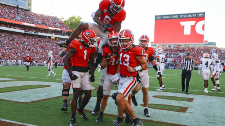 ATHENS, GA - OCTOBER 08: Stetson Bennett #13 of the Georgia Bulldogs reacts with teammates after scoring a touchdown in the second half against the Auburn Tigers at Sanford Stadium on October 8, 2022 in Athens, Georgia. (Photo by Todd Kirkland/Getty Images)