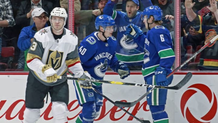 VANCOUVER, BC - NOVEMBER 29: Brayden McNabb #3 of the Vegas Golden Knights looks on dejected as Brock Boeser #6 of the Vancouver Canucks is congratulated by Elias Pettersson #40 after scoring during their NHL game at Rogers Arena November 29, 2018 in Vancouver, British Columbia, Canada. (Photo by Jeff Vinnick/NHLI via Getty Images)