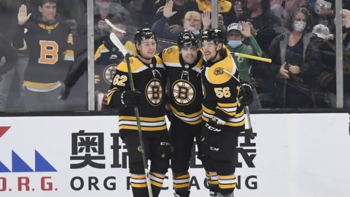 Oct 24, 2021; Boston, Massachusetts, USA; Boston Bruins left wing Jake DeBrusk (74) celebrates his goal with center Oskar Steen (62) and left wing Erik Haula (56) during the second period against the San Jose Sharks at TD Garden. Mandatory Credit: Bob DeChiara-USA TODAY Sports