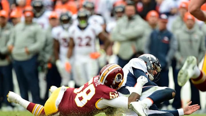 LANDOVER, MD - DECEMBER 24: Quarterback Brock Osweiler #17 of the Denver Broncos is tackled by linebacker Junior Galette #58 of the Washington Redskins in the first quarter at FedExField on December 24, 2017 in Landover, Maryland. (Photo by Patrick McDermott/Getty Images)
