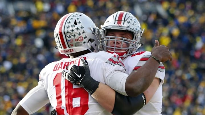 Nov 28, 2015; Ann Arbor, MI, USA; Ohio State Buckeyes quarterback J.T. Barrett (16) receives congratulations from offensive lineman Pat Elflein (65) in the fourth quarter against the Michigan Wolverines at Michigan Stadium. Mandatory Credit: Rick Osentoski-USA TODAY Sports