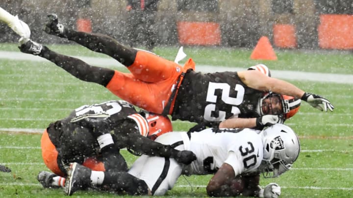 Nov 1, 2020; Cleveland, Ohio, USA; Cleveland Browns free safety Andrew Sendejo (23) and strong safety Karl Joseph (42) tackle Las Vegas Raiders running back Jalen Richard (30) during the first half at FirstEnergy Stadium. Mandatory Credit: Ken Blaze-USA TODAY Sports