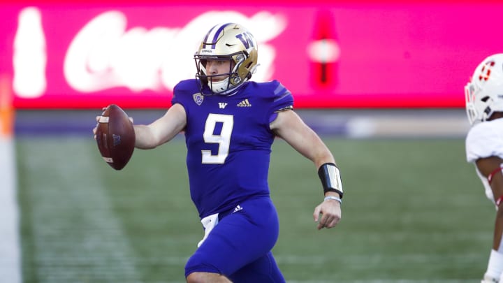 Dec 5, 2020; Seattle, Washington, USA; Washington Huskies quarterback Dylan Morris (9) reaches out for extra yardage against the Stanford Cardinal during the second quarter at Alaska Airlines Field at Husky Stadium. Mandatory Credit: Joe Nicholson-USA TODAY Sports