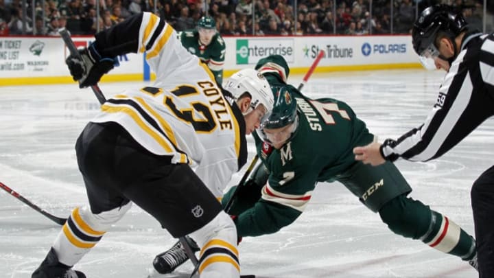 ST. PAUL, MN - APRIL 04: Charlie Coyle #13 of the Boston Bruins and Nico Sturm #7 of the Minnesota Wild face-off during a game at Xcel Energy Center on April 4, 2019 in St. Paul, Minnesota.(Photo by Bruce Kluckhohn/NHLI via Getty Images)