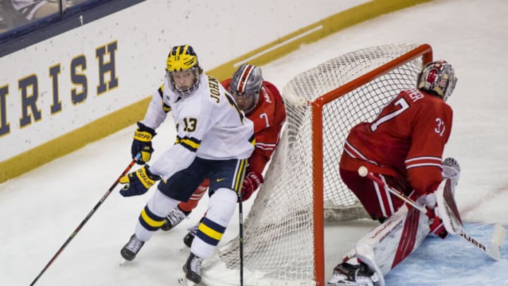 Mar 14, 2021; South Bend, IN, USA; Michigan’s Kent Johnson (13) wraps around the net as Ohio State's Evan McIntyre (7) chases him during the Michigan vs. Ohio State Big Ten Hockey Tournament game Sunday, March 14, 2021 at the Compton Family Ice Arena in South Bend. Mandatory Credit: Michael Caterina-USA TODAY Sports