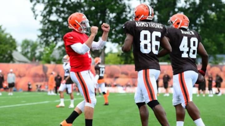 Jul 28, 2014; Berea, OH, USA; Cleveland Browns quarterback Johnny Manziel (2) celebrates with Anthony Armstrong (86) and Ray Agnew (48) after a touchdown during training camp at Cleveland Browns training facility. Mandatory Credit: Andrew Weber-USA TODAY Sports