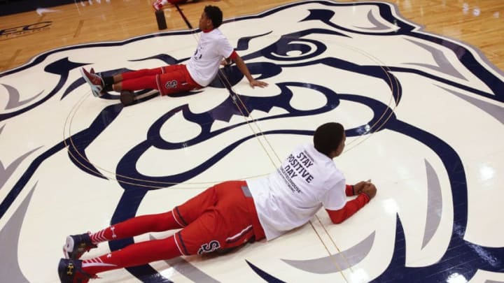 INDIANAPOLIS, IN - JANUARY 16: St. John's Red Storm players stretch before the game against the Butler Bulldogs wearing tee shirts honoring Butler player Andrew Smith at Hinkle Fieldhouse on January 16, 2016 in Indianapolis, Indiana. Butler defeated St John's 78-58. (Photo by Michael Hickey/Getty Images)