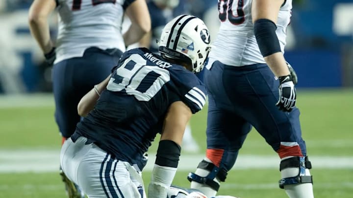 Oct 2, 2015; Provo, UT, USA; Brigham Young Cougars defensive lineman Bronson Kaufusi (90) gets up after hitting Connecticut Huskies quarterback Bryant Shirreffs (4) during the second half at Lavell Edwards Stadium. BYU won 30-13. Mandatory Credit: Russ Isabella-USA TODAY Sports