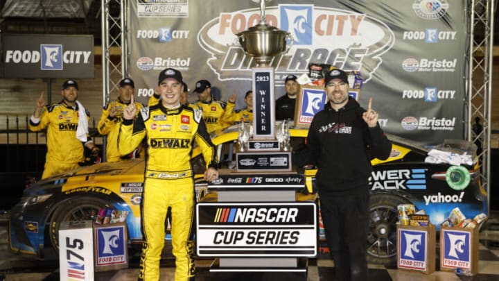 BRISTOL, TENNESSEE - APRIL 09: Christopher Bell, driver of the #20 DeWalt Power Stack Toyota, and crew chief Adam Stevens celebrate in victory lane after winning the NASCAR Cup Series Food City Dirt Race at Bristol Motor Speedway on April 09, 2023 in Bristol, Tennessee. (Photo by Jared C. Tilton/Getty Images)