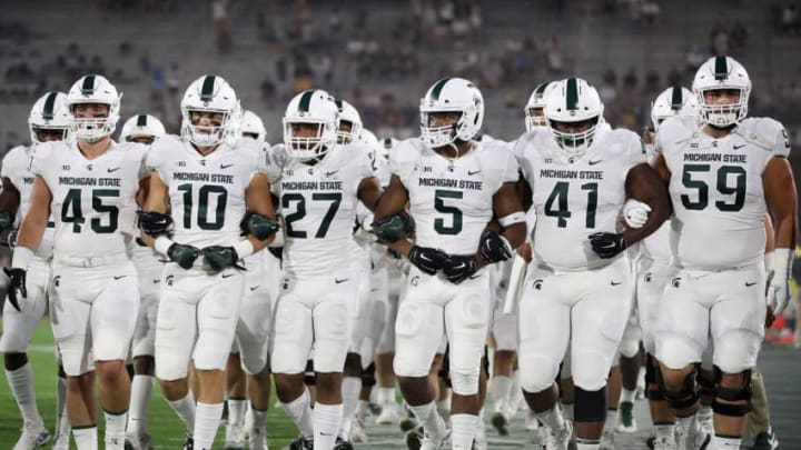 TEMPE, AZ - SEPTEMBER 08: The Michigan State Spartans walk arm in arm onto the field before the college football game against the Arizona State Sun Devils at Sun Devil Stadium on September 8, 2018 in Tempe, Arizona. (Photo by Christian Petersen/Getty Images)