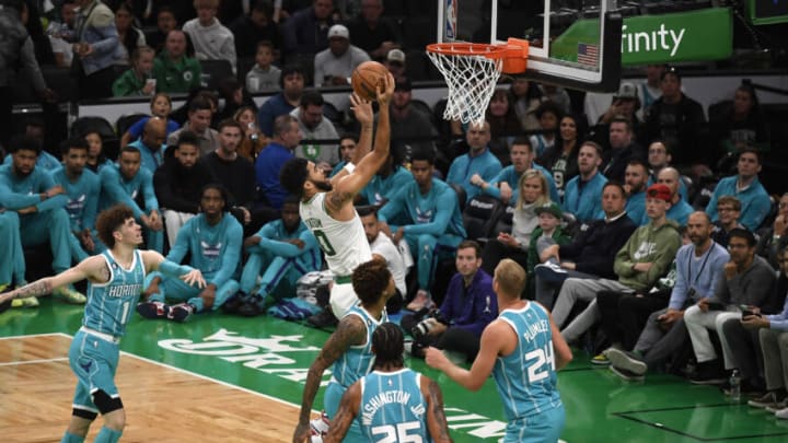 Oct 2, 2022; Boston, Massachusetts, USA; Boston Celtics forward Jayson Tatum (0) drives to the basket while Charlotte Hornets forward P.J. Washington (25) and center Mason Plumlee (24) look on during the first half at TD Garden. Mandatory Credit: Bob DeChiara-USA TODAY Sports