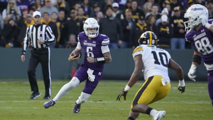 Nov 4, 2023; Chicago, Illinois, USA; Northwestern Wildcats quarterback Brendan Sullivan (6) runs against the Iowa Hawkeyes during the second half at Wrigley Field. Mandatory Credit: David Banks-USA TODAY Sports