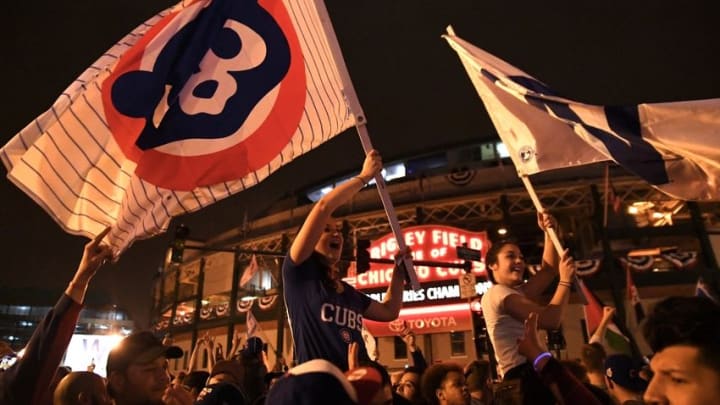 Nov 2, 2016; Cleveland, OH, USA; Lindsey Balamut (left) and Kayla Gillen (right) fly flags in celebration after game seven of the 2016 World Series against the Cleveland Indians outside of Wrigley Field. Cubs won 8-7. Mandatory Credit: Patrick Gorski-USA TODAY Sports