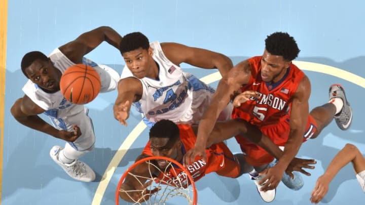 Dec 30, 2015; Chapel Hill, NC, USA; North Carolina Tar Heels forwards Theo Pinson (1) and Isaiah Hicks (4) and Clemson Tigers center Landry Nnoko (35) and forward Jaron Blossomgame (5) fight for the ball in the second half. The Tar Heels defeated the Tigers 80-69 at Dean E. Smith Center. Mandatory Credit: Bob Donnan-USA TODAY Sports