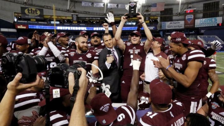 ST. PETERSBURG, FL - DECEMBER 26: Quarterback Nick Fitzgerald #7 of the Mississippi State Bulldogs hoists the MVP trophy after his team won 17-16 over the Miami (Oh) Redhawks in the St. Petersburg Bowl at Tropicana Field on December 26, 2016, in St. Petersburg, Florida. (Photo by Joseph Garnett, Jr. /Getty Images)