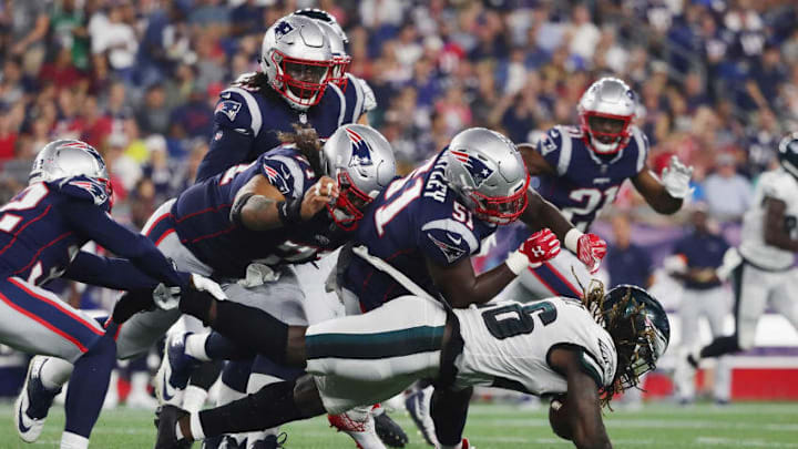 FOXBOROUGH, MA - AUGUST 16: Jay Ajayi #26 of the Philadelphia Eagles is tackled by the New England Patriots defense in the second quarter during the preseason game at Gillette Stadium on August 16, 2018 in Foxborough, Massachusetts. (Photo by Tim Bradbury/Getty Images)