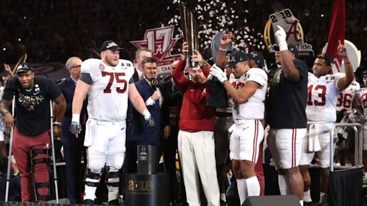 ATLANTA, GA - JANUARY 08: Head coach Nick Saban of the Alabama Crimson Tide holds the trophy while celebrating with his team after defeating the Georgia Bulldogs in overtime to win the CFP National Championship presented by AT