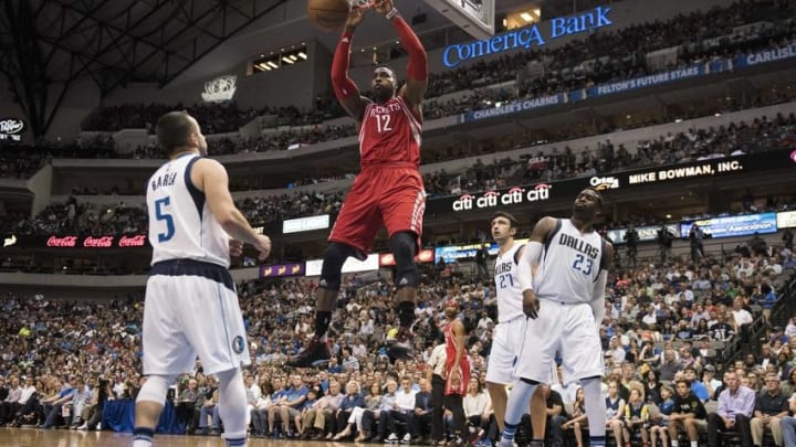 Apr 6, 2016; Dallas, TX, USA; Houston Rockets center Dwight Howard (12) dunks the ball as Dallas Mavericks guard J.J. Barea (5) and guard Wesley Matthews (23) and center Zaza Pachulia (27) look on during the second half at the American Airlines Center. The Mavericks defeat the Rockets 88-86. Mandatory Credit: Jerome Miron-USA TODAY Sports