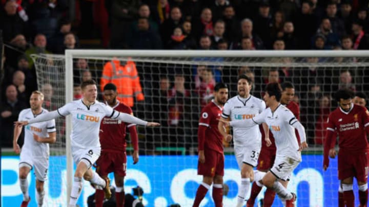 Swansea goalscorer Alfie Mawson celebrates the opening goal during the Premier League match between Swansea City and Liverpool at Liberty Stadium. (Photo by Stu Forster/Getty Images)