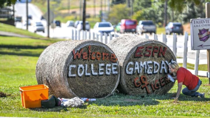 Catherine Garrison Davis, Clemson University class of 1995, of Anderson paints two hay bales with "Welcome ESPN College Gameday" in front of the Denver Downs farm along Clemson Boulevard Monday, September 26, 2022. Clemson football plays a 7:30 p.m. game in Memorial Stadium with ACC conference rival North Carolina State, a game which television network ESPN will set up a stage on Bowman Field on campus for the Tigers' eighth College Gameday appearance.Denver Downs College Gameday Display