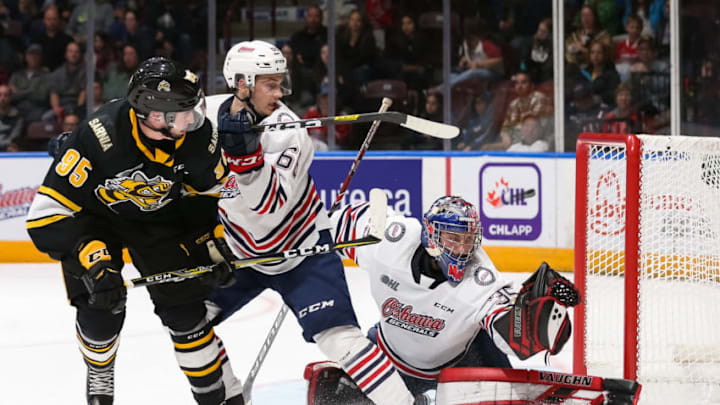 OSHAWA, ON - October 18: Andrew Maclean #35 of the Oshawa Generals makes a glove save while his teammate Nico Gross #66 battles for position with Justin Nolet #95 of the Sarnia Sting during an OHL game at the Tribute Communities Centre on October 18, 2019 in Oshawa, Ontario, Canada. (Photo by Chris Tanouye/Getty Images)