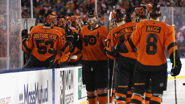 PHILADELPHIA, PA - FEBRUARY 23: Sean Couturier #14 of the Philadelphia Flyers skates by the Flyers bench to celebrate after his goal during the first period of the 2019 Coors Light NHL Stadium Series game between the Pittsburgh Penguins and the Philadelphia Flyers at Lincoln Financial Field on February 23, 2019 in Philadelphia, Pennsylvania. (Photo by Andre Ringuette/NHLI via Getty Images)