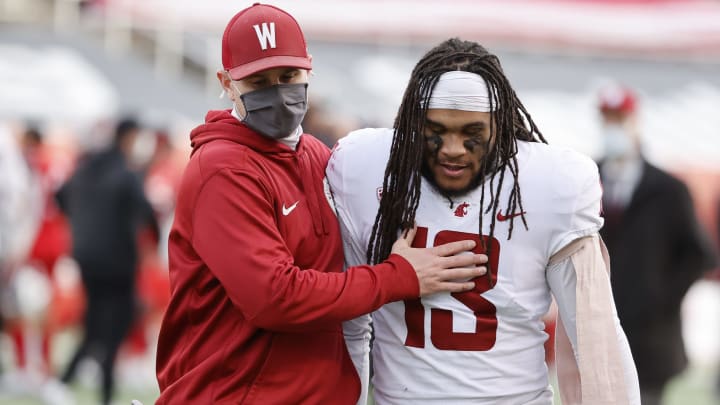 Dec 19, 2020; Salt Lake City, Utah, USA; Washington State Cougars linebacker Jahad Woods (13) is consoled after losing the Utah Utes at Rice-Eccles Stadium. Mandatory Credit: Jeffrey Swinger-USA TODAY Sports