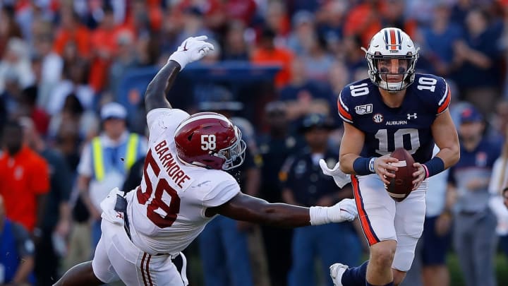 AUBURN, ALABAMA – NOVEMBER 30: Bo Nix #10 of the Auburn Tigers breaks a tackle by Christian Barmore #58 of the Alabama Crimson Tide in the first half at Jordan Hare Stadium on November 30, 2019 in Auburn, Alabama. (Photo by Kevin C. Cox/Getty Images)