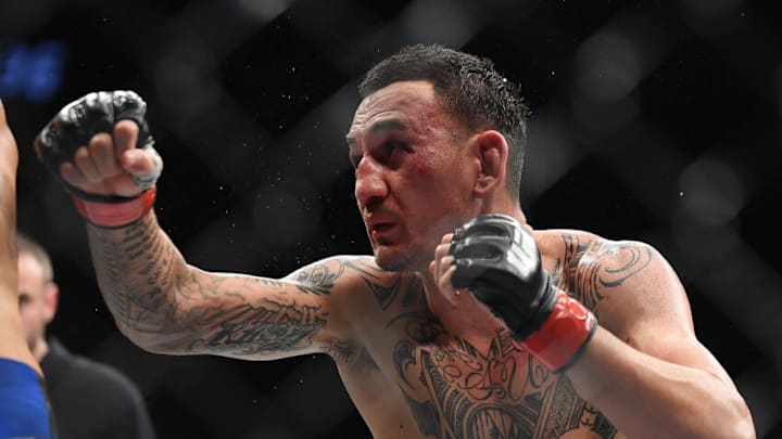 ATLANTA, GEORGIA - APRIL 13: Max Holloway punches Dustin Poirier during the UFC 236 event at State Farm Arena on April 13, 2019 in Atlanta, Georgia. (Photo by Logan Riely/Getty Images)