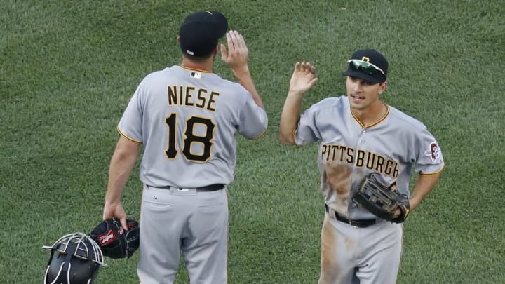 Jul 17, 2016; Washington, DC, USA; Pittsburgh Pirates starting pitcher Jonathon Niese (18) celebrates with Pirates second baseman Adam Frazier (26) after their game against the Washington Nationals at Nationals Park. The Pirates won 2-1 in eighteen innings. Mandatory Credit: Geoff Burke-USA TODAY Sports
