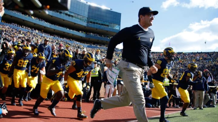 ANN ARBOR, MI - OCTOBER 22: Head coach Jim Harbaugh of the Michigan Wolverines leads the team onto the field prior to playing the Illinois Fighting Illini on October 22, 2016 at Michigan Stadium in Ann Arbor, Michigan. Michigan won the game 41-8. (Photo by Gregory Shamus/Getty Images)